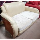 An Art Deco 2 seater settee with exposed walnut fascia, in cream leather effect