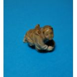 A Japanese Meiji peroid ivory Netsuke of a man cleaning a floor with a rat on his back