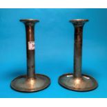 A pair of plain cylindrical silver cased candlesticks, circular base, Sheffield, 1928, 7" high