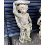 A reconstituted stone cherub plant stand