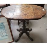 A Victorian inlaid games/occasional table, with shaped oval top on turned column an d 4 splay feet