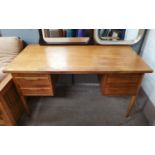 A light oak desk with drawers either side