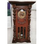 A 19th century walnut cased Vienna wall clock, striking movement, 34"