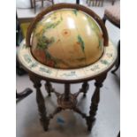 A reproduction globe on stand, with hand painted effect decoration, with zodiac signs to base