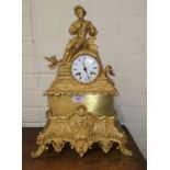 A 19th century French mantel clock in ormolu case surmounted by a reclining man in renaissance