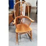 A modern Windsor style rocking armchair with beech frame