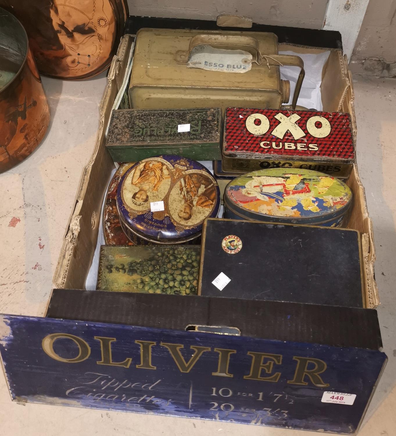 An early 20th century glass advertising sign for Olivier cigarettes; a collection of old tins; a