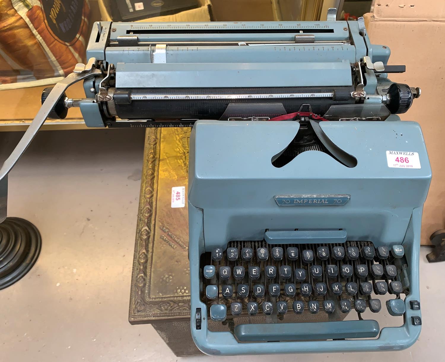 An Imperial manual typewriter; an AEG portable typewriter; a vintage Roberts radio; a slide