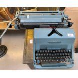 An Imperial manual typewriter; an AEG portable typewriter; a vintage Roberts radio; a slide