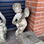 A reconstituted stone cherub and similar pedestal