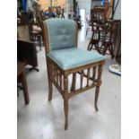 An Edwardian music chair with spindle gallery, green brocade upholstered eat and back; a square