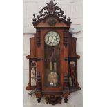 An unusual Vienna wall clock in walnut case, with ornate carved pediment and part side columns,
