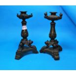A 19th century pair of Empire style candlesticks with 3 paw feet