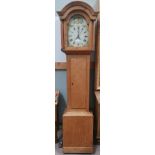 A 19th century pine 30 hour longcase clock with arch top hood and turned pillars, full length door