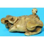 A Meiji period netsuke depicting a boy with recumbent buffalo, signature to base