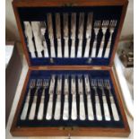 A canteen of dessert cutlery with mother-of-pearl handles, in oak case