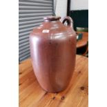 A large brown stoneware flagon