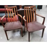 A pair of G-Plan teak carver chairs with slat backs