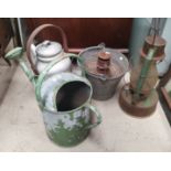 Two vintage hurricane lamps; a watering can; bucket and aluminium kettle; a wrought iron panel