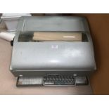 A vintage teleprinter with keyboard and GPO logo to cover with some original documents