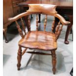 A late 19th century elm and beech smoker's bow armchair