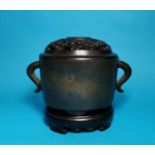 An oval bronze 2 handled Chinese censor with pierced lid, relief character signature to base and