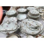 A continental Limoges style large dinner service: soup tureen and bowls; meat plates; dinner and