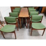 A 1960's teak dining suite comprising oval drop leaf table and 8 chairs,in green fabric, by