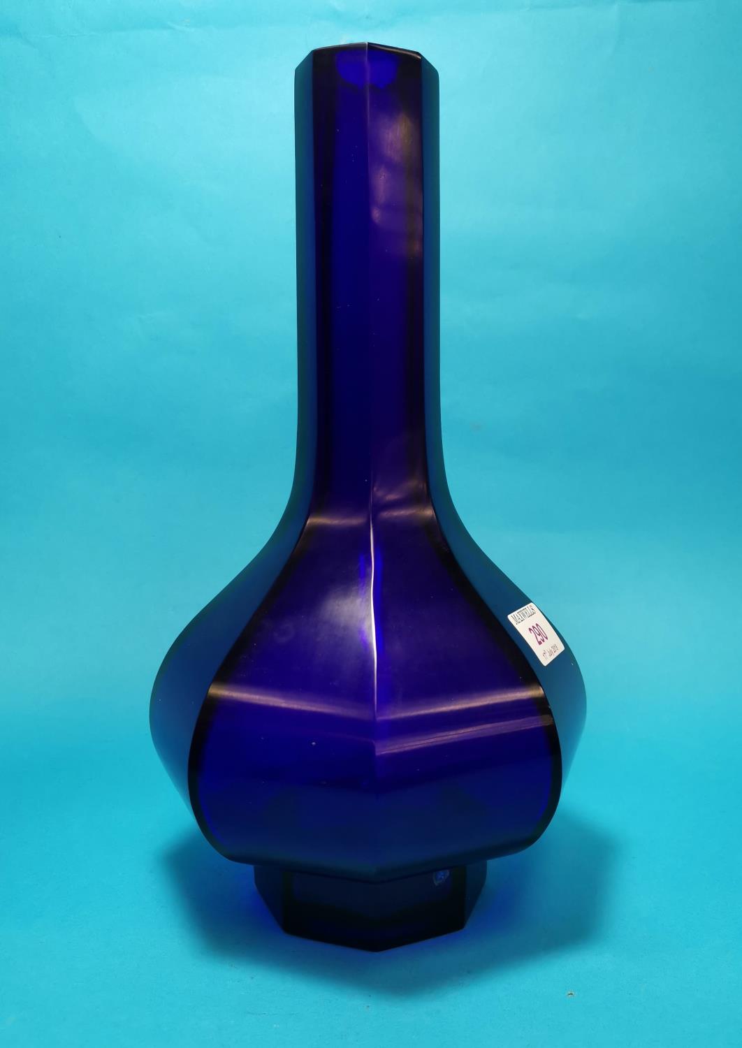 An octagonal baluster deep blue 'Peking' glass vase with tall slender neck and raised foot,