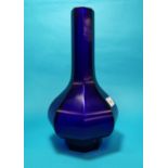 An octagonal baluster deep blue 'Peking' glass vase with tall slender neck and raised foot,