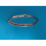 A 9 carat white gold hinged bangle in 7 sections set white and black stones, 11 gm gross