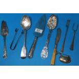 A silver basting spoon; a pair of sugar tongs; a pie slice; berry spoons; etc