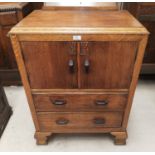 A 1930's oak tallboy with double cupboard and 2 drawers