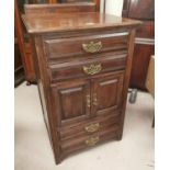 An Edwardian walnut music cabinet with 4 drawers and double cupboard