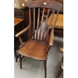 A 19th century beech armchair with lath back and solid seat