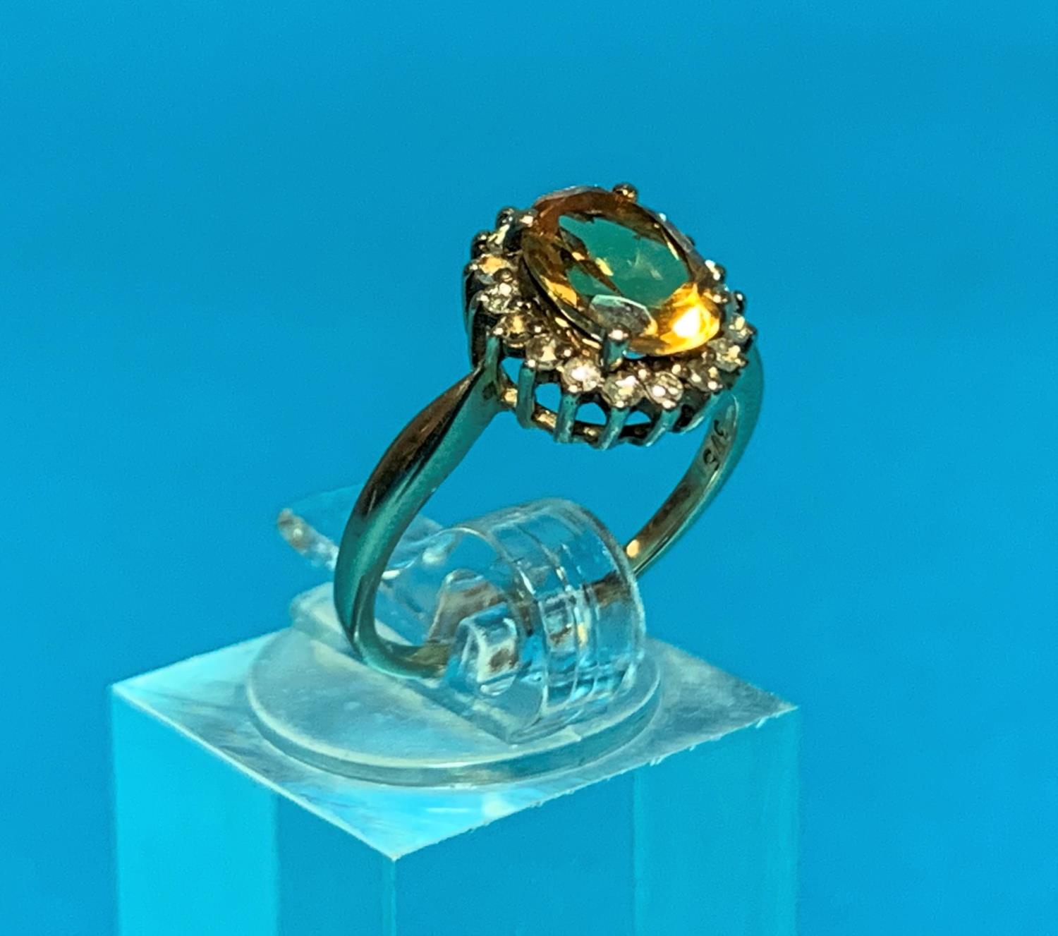 A Ladies 9ct hall marked gold dress ring set with a central oval facetted citrine coloured stone