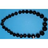 A Whitby Jet necklace of large faceted graduating beads largest 10mm and full length approx 60cm