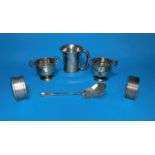A selection of silver: a small mug; a pair of miniature trophy cups; 2 napkin rings; etc., various