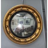 A convex circular wall mirror in gilt ball frame