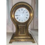 An Edwardian brass mantel clock with balloon top, white enamel dial and French balance spring
