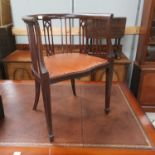 An Edwardian inlaid tub shaped armchair; a pair of cane seat bedroom chairs; a mahogany wine table