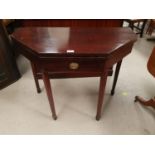 A 19th century canted rectangular fold over card table with frieze drawer and square tapering legs