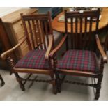 A 1930's pair of oak rail back carver chairs with tartan seats