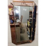 A wall mirror in Art Deco peach frame