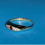 A hallmarked gypsy style ring inset with 4 small clear and one ruby colour stones, Chester 1919, 1.