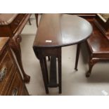 A 1930's cane back low seat armchair;An early 20th century mahogany drop leaf occasional table