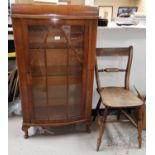 A 1950's walnut display cabinet with single door, on cabriole legs; an oak cased mantel clock