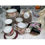 A continental 32 piece part tea service with wide gilt polychrome floral border; 10 pieces of