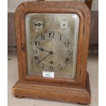 An Edwardian oak cased mantel clock with silvered dial and chiming movement