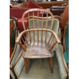 A 19th century child's elm Windsor armchair with stick back and solid seat, on turned legs